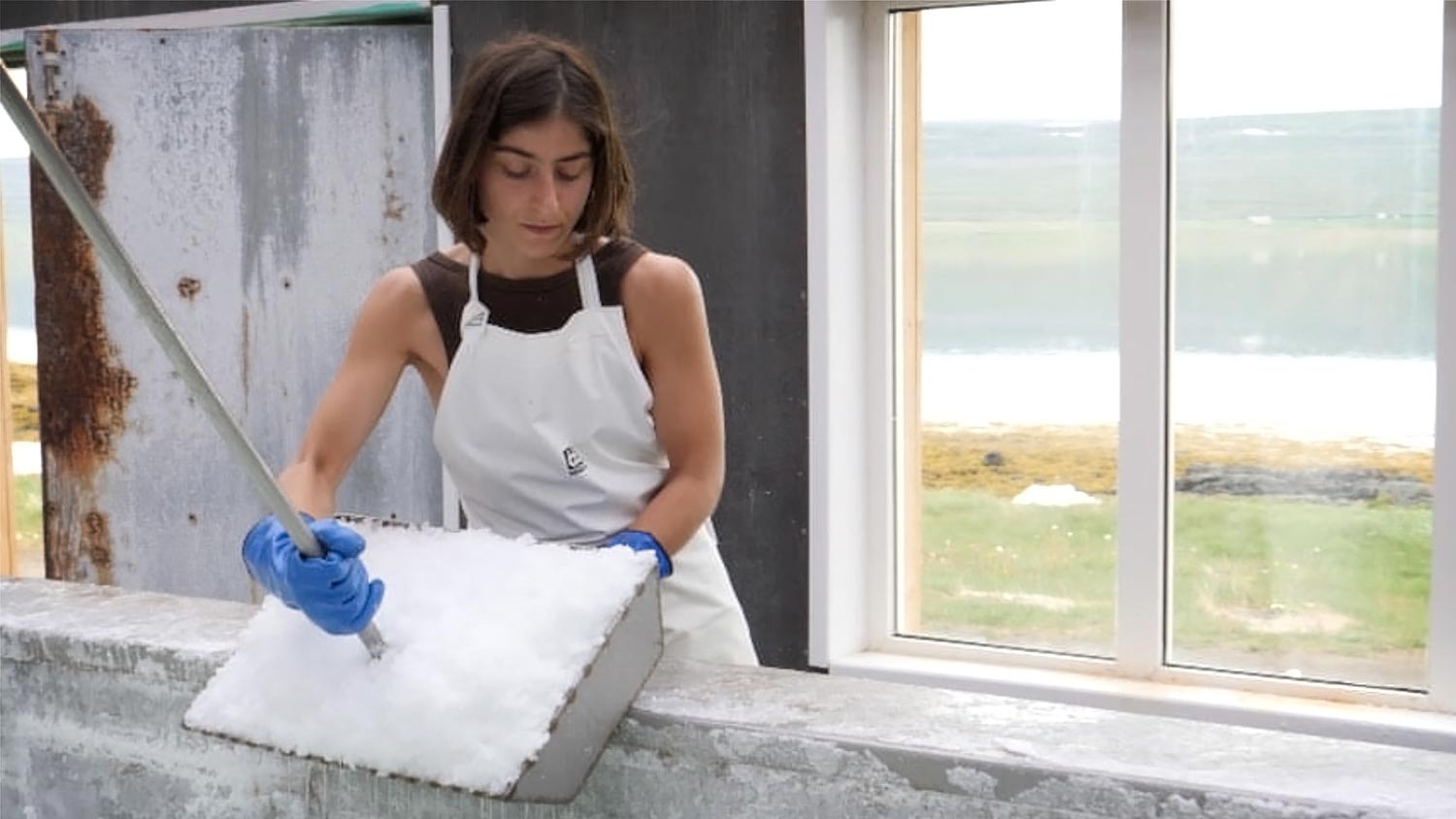 Young woman harvesting salt.